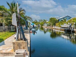 A canal with a boat dock, a house, and a fence. - Paradise Calling Florida (Monroe County)