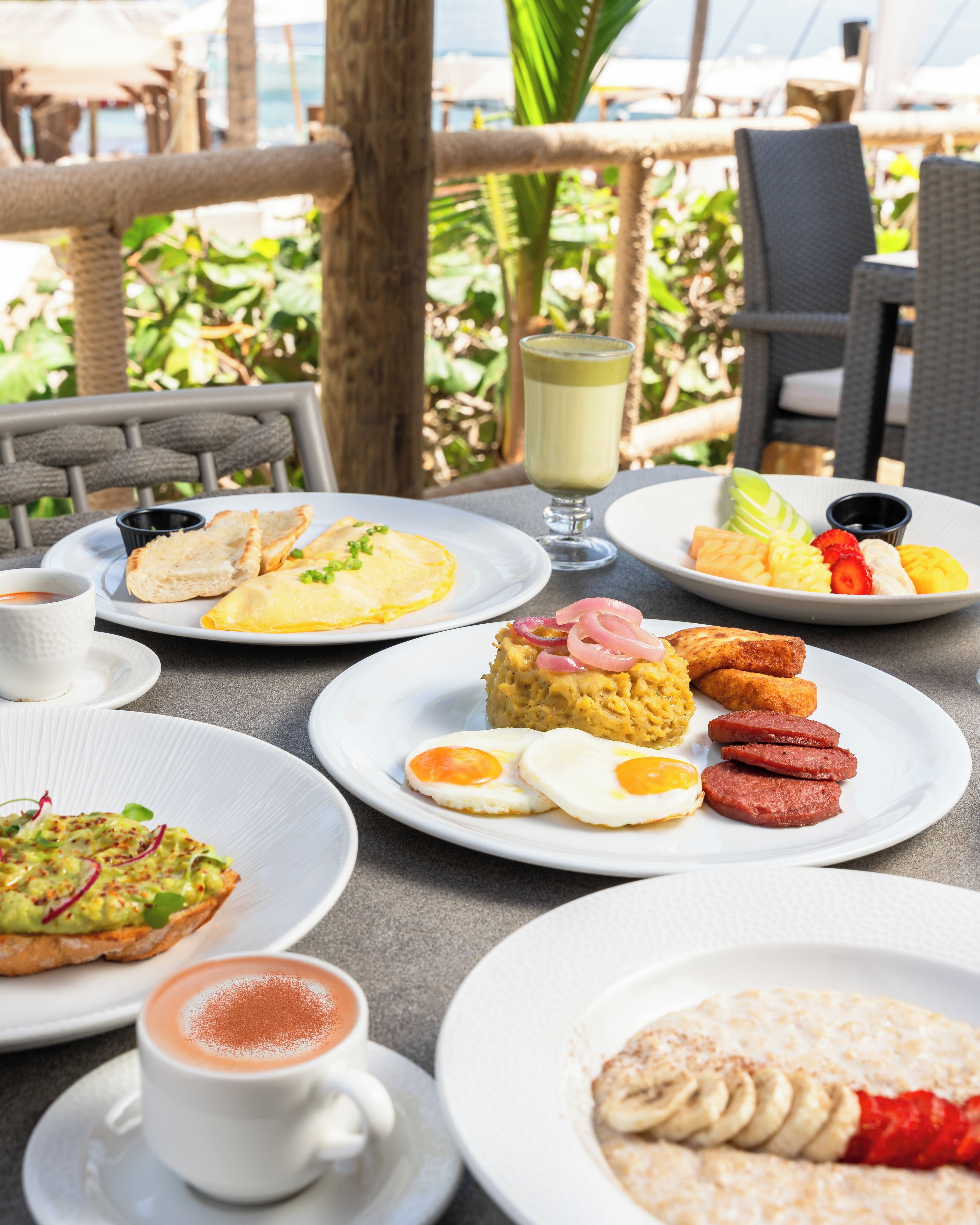A table set with breakfast items including eggs, toast, and fruit.