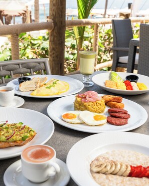 A table set with breakfast items including eggs, toast, and fruit.