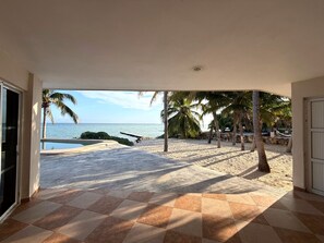 A covered patio with a view of the beach and ocean. - A genuine Yucatecan Summer House by the Sea (Chicxulub)