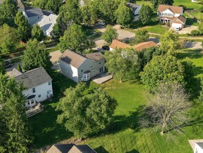 A residential area with multiple houses, lawns, and trees.