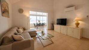 A living room with a sofa, coffee table, TV, and cabinets. - Villa Sabina, Golf del Sur (San Miguel de Abona)
