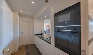 A modern kitchen with a Bosch oven and a built-in sink. - LUXURY FLORENCE APARTMENT WITH PANORAMIC VIEWS & TURKISH BATH (Firenze)