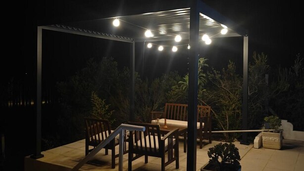 An outdoor patio area with a pergola, seating, and potted plants. - Apartment 'Casa Laranjeira' with Mountain View, Wi-Fi and Air Conditioning (Melides)