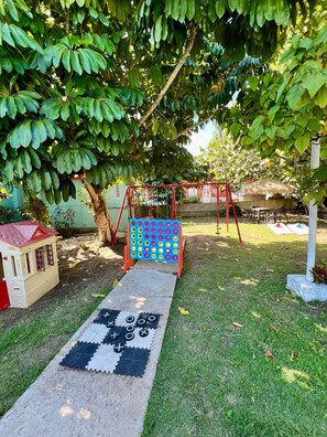Shaded garden grounds with towering trees for a peaceful escape - Coastal Stay Near Beach w/ Pool Access and Patio (Boquerón)