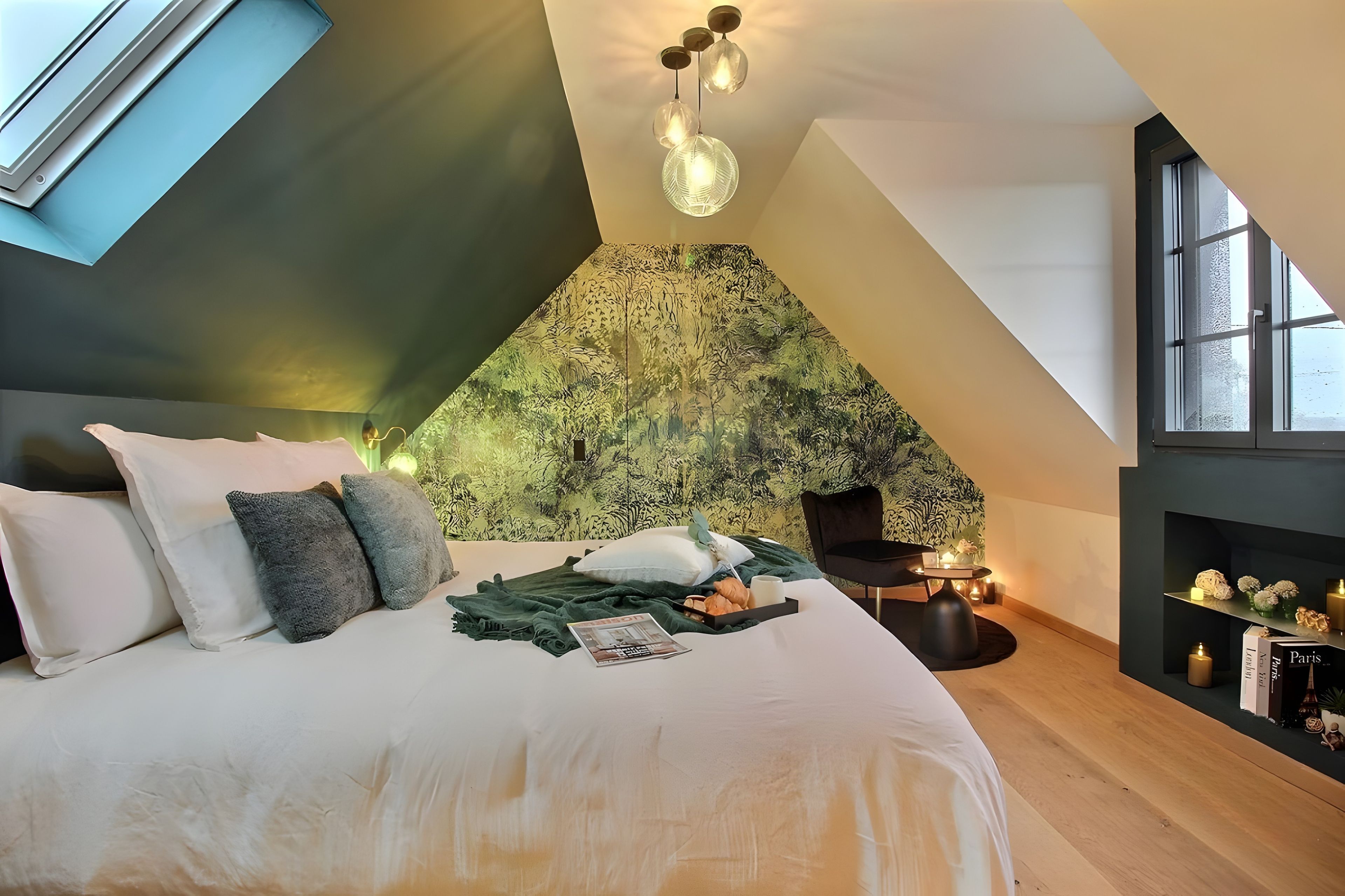Une chambre moderne avec un plafond en pente, un grand lit, une table de chevet et une bibliothèque.