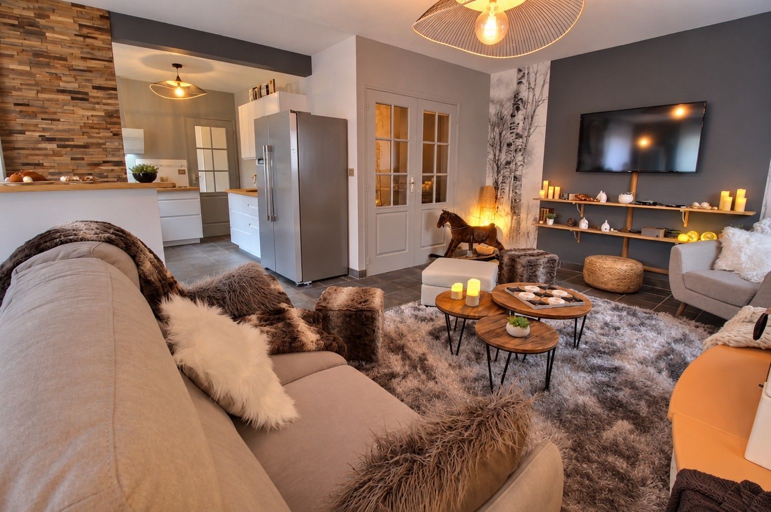 A modern living room with a sofa, coffee table, and a television.
