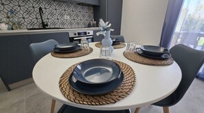A dining table set with plates, glasses, and a vase. - Brucoli Blue Charme, your luxury oasis with a private pool and garden (Brucoli (SR))
