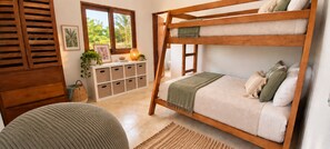 A bunk bed with a wooden frame, a bedside table with a lamp, and a view of greenery outside. - Jungle Bliss Villa | Large Private Pool, Ocean Glimpses & Sunsets (Sayulita)