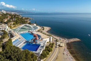 An aerial view of a coastal area with a swimming pool, beach, and a view of the sea. - Luxury 100 m2, 2-bedroom apartment with balcony & garden (Rijeka)