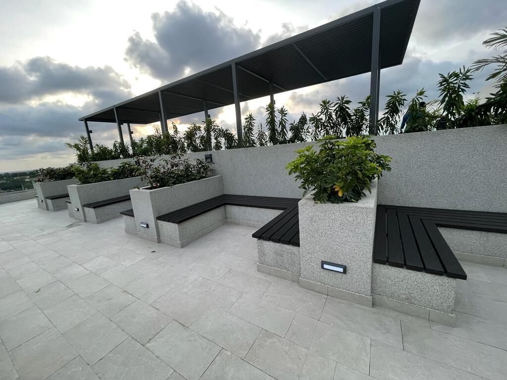 Outdoor seating areas with built-in planters and a covered walkway.