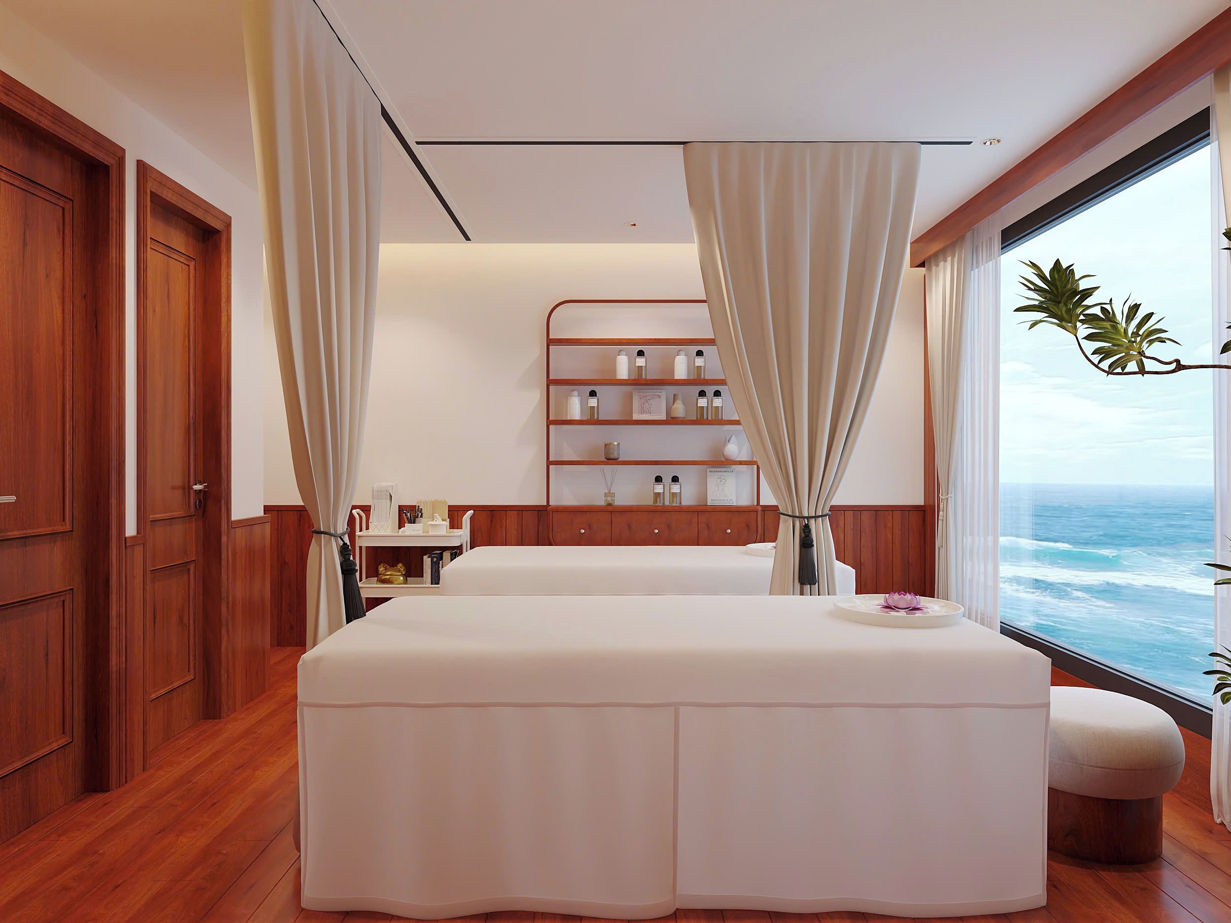 Een slaapkamer met een groot bed, een nachtkastje, een plank met toiletartikelen en een raam met uitzicht op zee.
