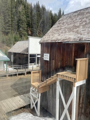 A rustic wooden building with a sign reading 'NICOLE HOTEL.' - Room 4 - St. George Hotel (Barkerville)