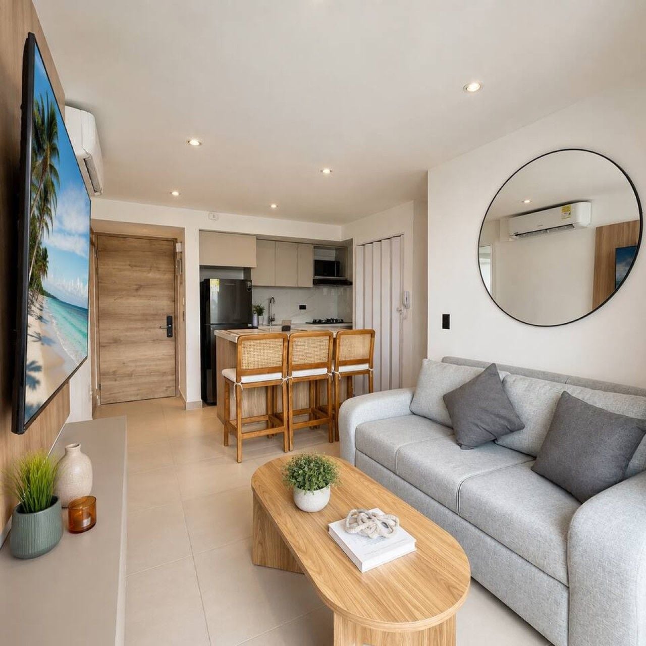 A modern living room with a sofa, a coffee table, and a dining area with chairs.