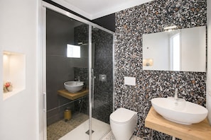 A modern bathroom with a glass shower enclosure, a white toilet, and a wooden vanity with a white sink. - Don Filippo Luxury Home - Vesuvia (Naples)