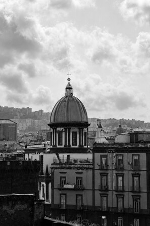 A historic building with a prominent dome and cross, surrounded by urban structures. - Don Filippo Luxury Home - Riviera (Naples)