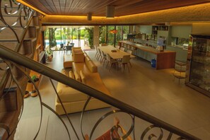 A spacious interior with a dining area, kitchen, and a staircase.