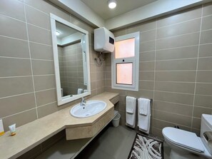 A bathroom with a sink, mirror, towel rack, and toilet. - VESTA - Luxury APT - 2BR - Joubal (El Gouna)
