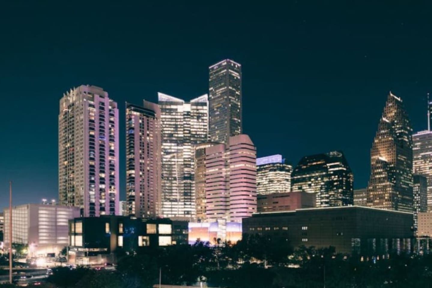 A nighttime cityscape with high-rise buildings.