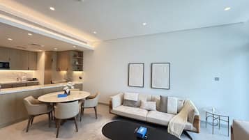 A modern living room with a round dining table, a sofa, and a coffee table.