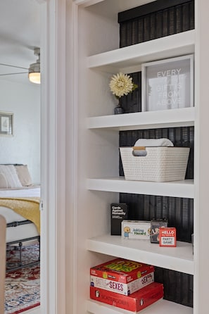 A bookshelf with various board games and a decorative item. - Min 2 Mayo Clinic, St. Joseph's Hospital, Chase Stadium, Desert Botanical Garden (Phoenix)