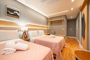 A hotel room with two beds, a bedside table with a lamp, a mirror, and a wardrobe. - Vêneto Vicenza 103 (Gramado)