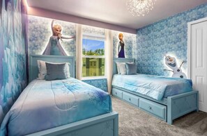 A bedroom with two beds, a window, and a wall with a character print. - 5BR house with private pool in Storey Lake (Kissimmee)