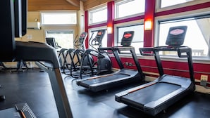 A gym with treadmills and exercise equipment.
