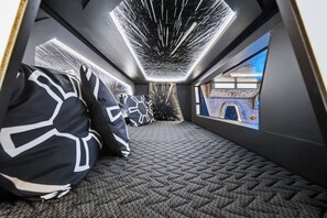 A modern interior with a geometric patterned carpet, black and white pillows, and a large window with a cityscape view. - 7BR house with private pool in clermont (Clermont)