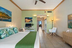 A hotel room with a bed, a desk, a TV, and a view of the hallway. - Lahaina Shores Beach Resort, Ocean Views Sleeps 5 (Lahaina)