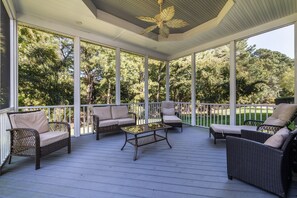 A covered outdoor seating area with wicker furniture and a ceiling fan. - Coastal Fun at Bayside Resort | Near the Beach (Selbyville)