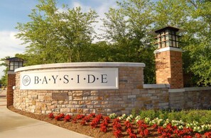 A stone wall with a sign reading "BAYSIDE" and a brick chimney. - Coastal Fun at Bayside Resort | Near the Beach (Selbyville)