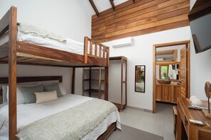 A bunk bed with a wooden headboard and a bedside table with a mirror. - Casa Moana l Luxury Balinese Villa- AC-Golf Cart (Playa Avellanas)