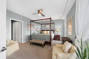 A spacious bedroom with a four-poster canopy bed and comfortable armchairs. - New! 3Bd 3Bth Oceanfront / Pool / Gym / Beach (Virginia Beach)