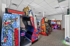 An indoor arcade room equipped with several video game cabinets. - New! 3Bd 3Bth Oceanfront / Pool / Gym / Beach (Virginia Beach)