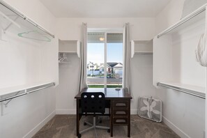 A compact room with a desk, chair, and a window with curtains. - Spacious 6-bedroom house in lovely American Fork with AC (American Fork)