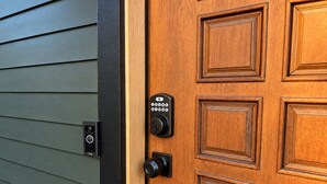 A wooden door with a keypad lock and a doorbell. - 
The Perch  2BR Eagle Rock Home + Views near DTLA (Los Angeles)