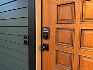 A wooden door with a keypad lock and a doorbell. - 
The Perch  2BR Eagle Rock Home + Views near DTLA (Los Angeles)
