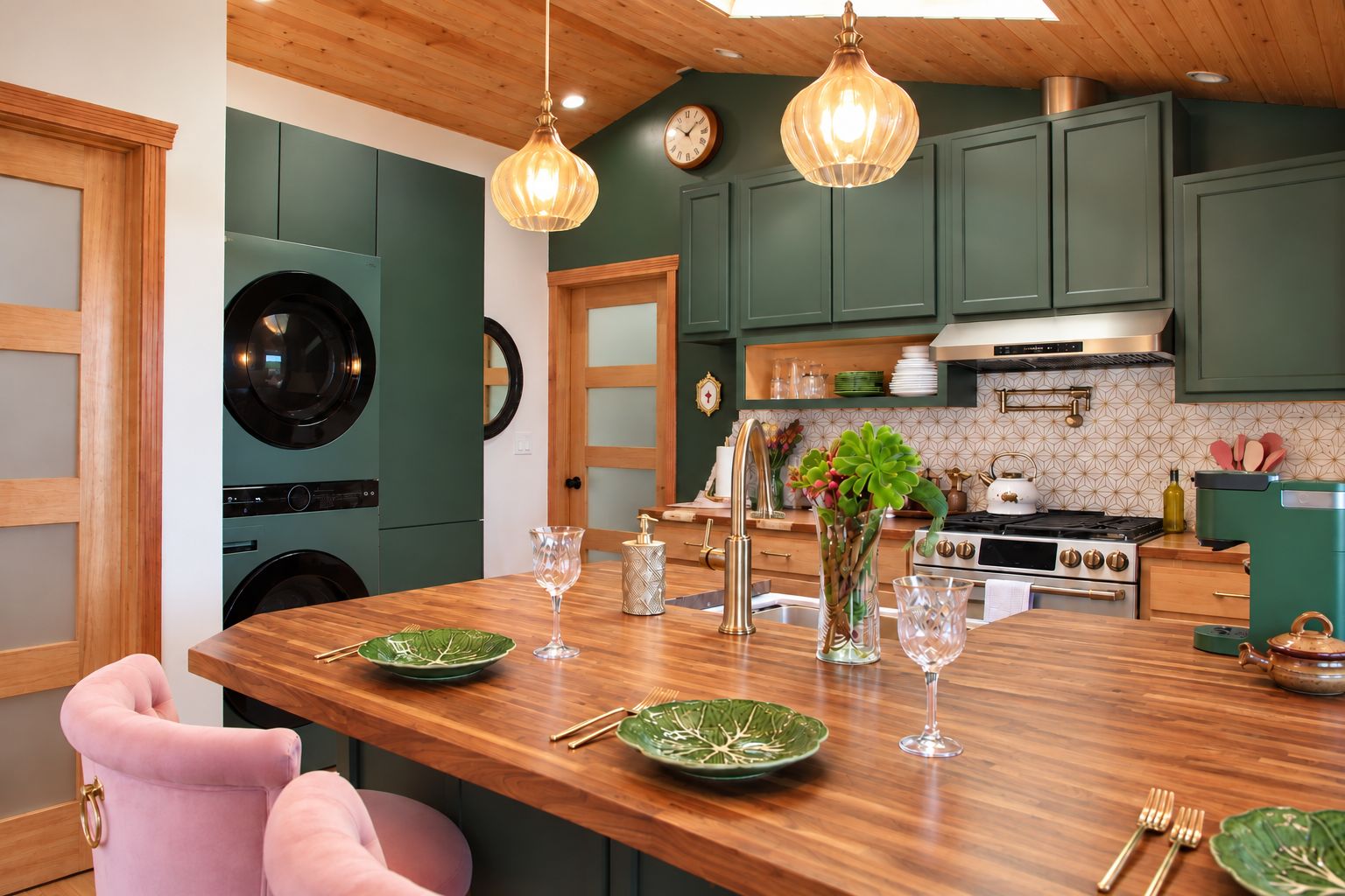 A kitchen with a wooden island, green cabinets, a stainless steel stove, and a hanging light fixture.