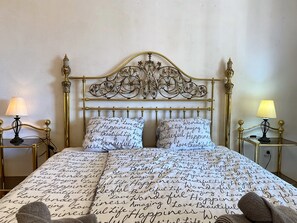 Ein Bett mit einem dekorativen Kopfteil und zwei Nachttischlampen.