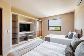 A modern bedroom with two beds, built-in TV, wardrobe, and a large window with a view. - Artila Isla Mujeres: The Ocean Dream Sanctuary (Isla Mujeres)