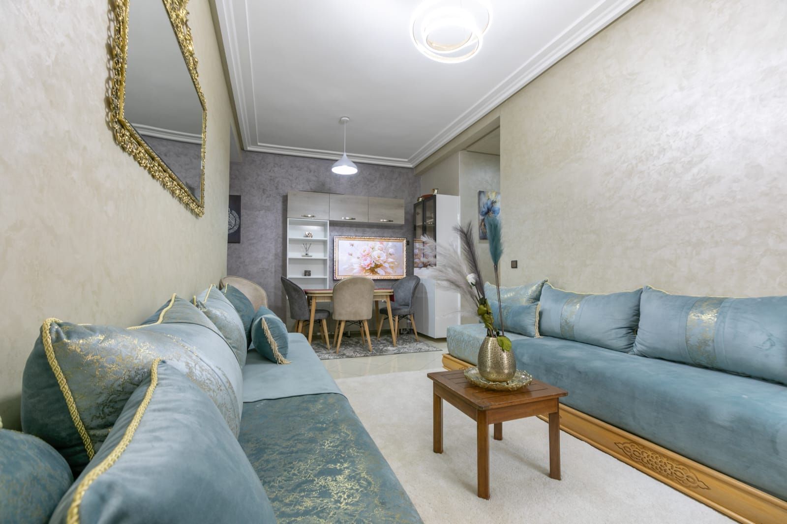 Ein Wohnzimmer mit einer Couch, einem Couchtisch und einem Essbereich mit Stühlen und einem Tisch.