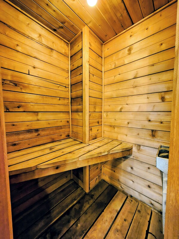 A wooden sauna with benches and a bench seat.
