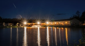 A lakeside property with a wooden building, a dock, and a fountain. - Silverwood Resort & events Barn  (Perth)