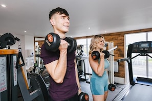 A gym with exercise equipment, a treadmill, and a window with a view. - Silverwood Resort & events Barn  (Perth)