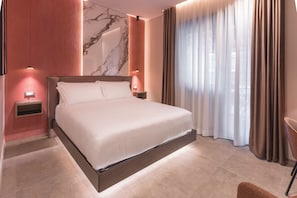 A modern hotel room with a large bed, marble wall, and a view of the outdoors. - AF Luxury Rooms (Rome)