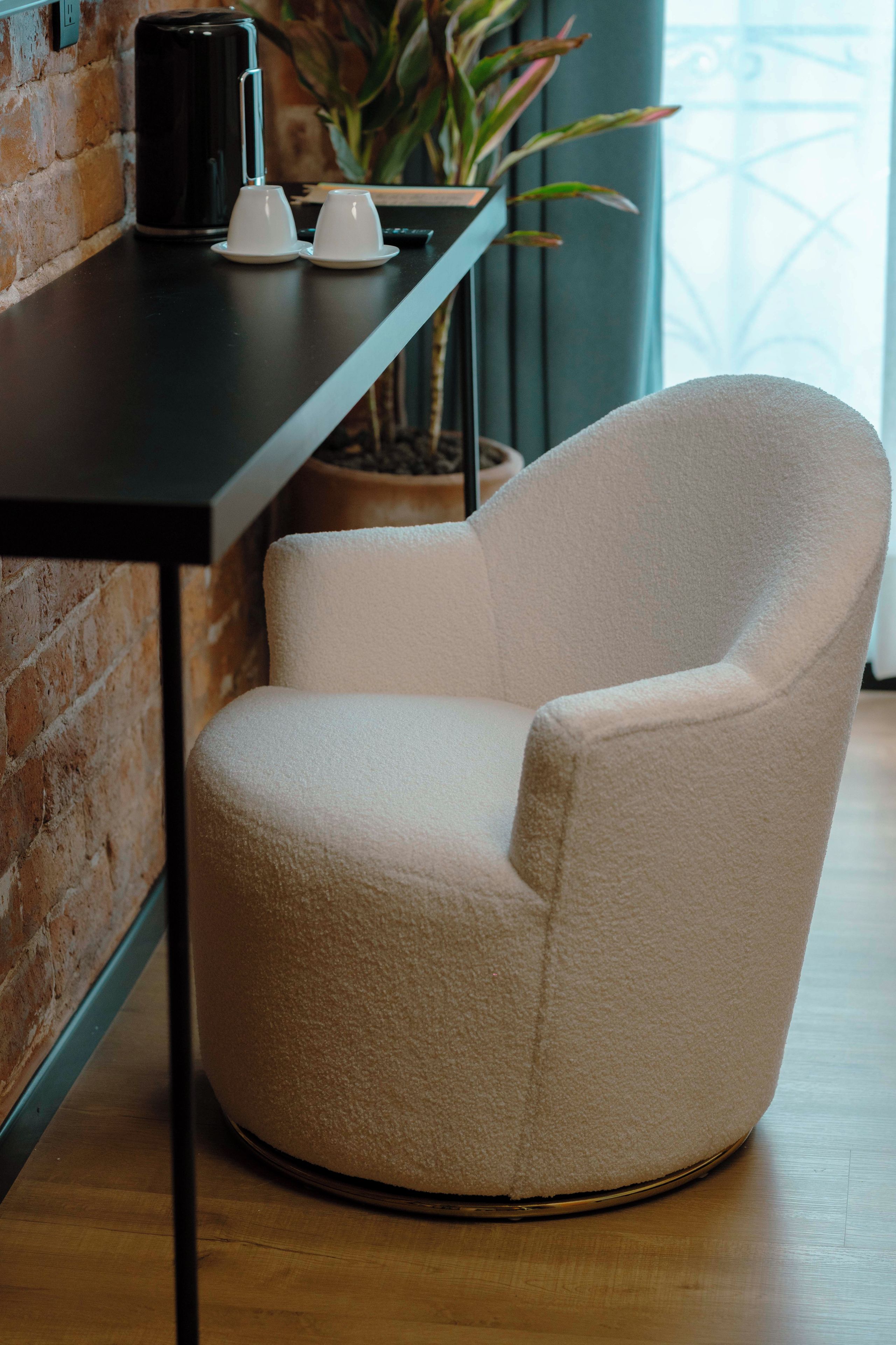 A chair with a textured fabric seat and backrest, positioned on a wooden floor.