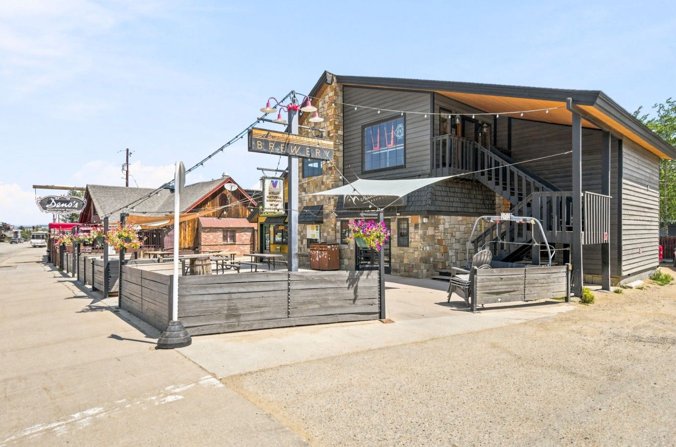 A building with a sign reading 'BREWERY' and a staircase leading to a covered area.