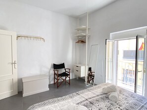 A bedroom with a bed, a chair, a desk, a mirror, and a wardrobe. - Holiday House in Nerja With Sea Views (Nerja)