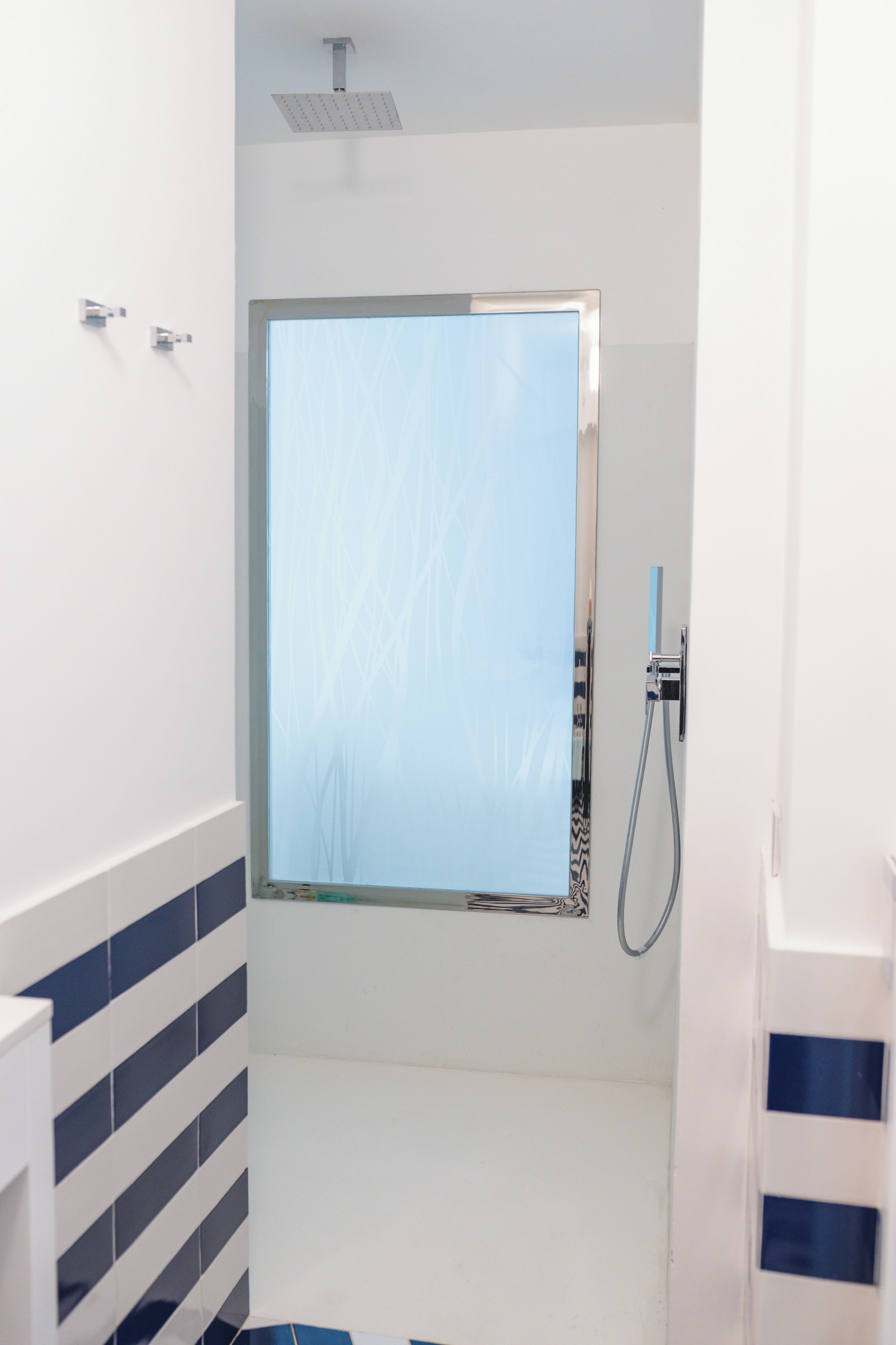 A bathroom with a shower, a toilet, and a sink.